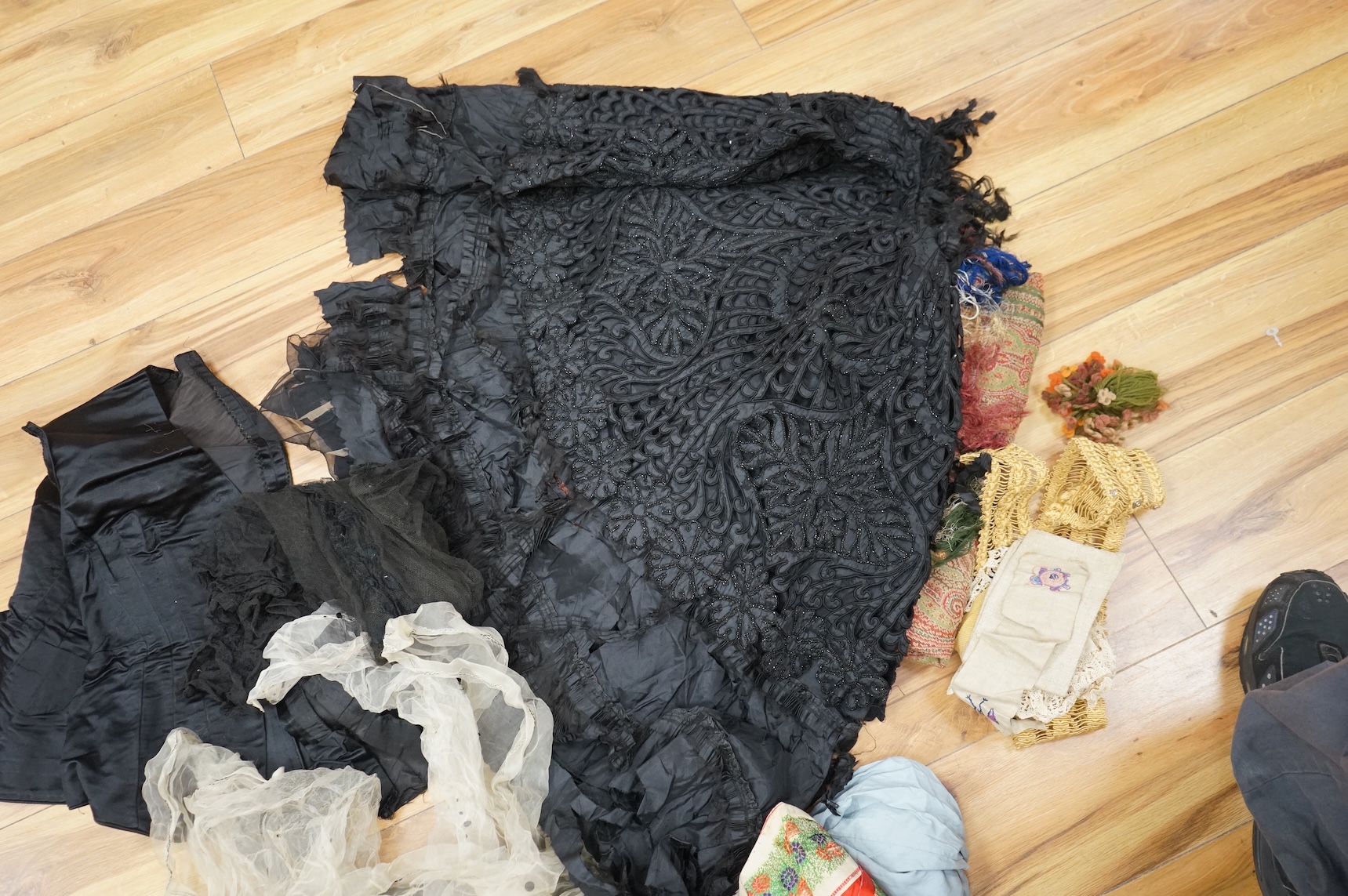 A collection of 19th century fabric and clothing, including a woven Paisley shawl, good for film and TV costume dramas